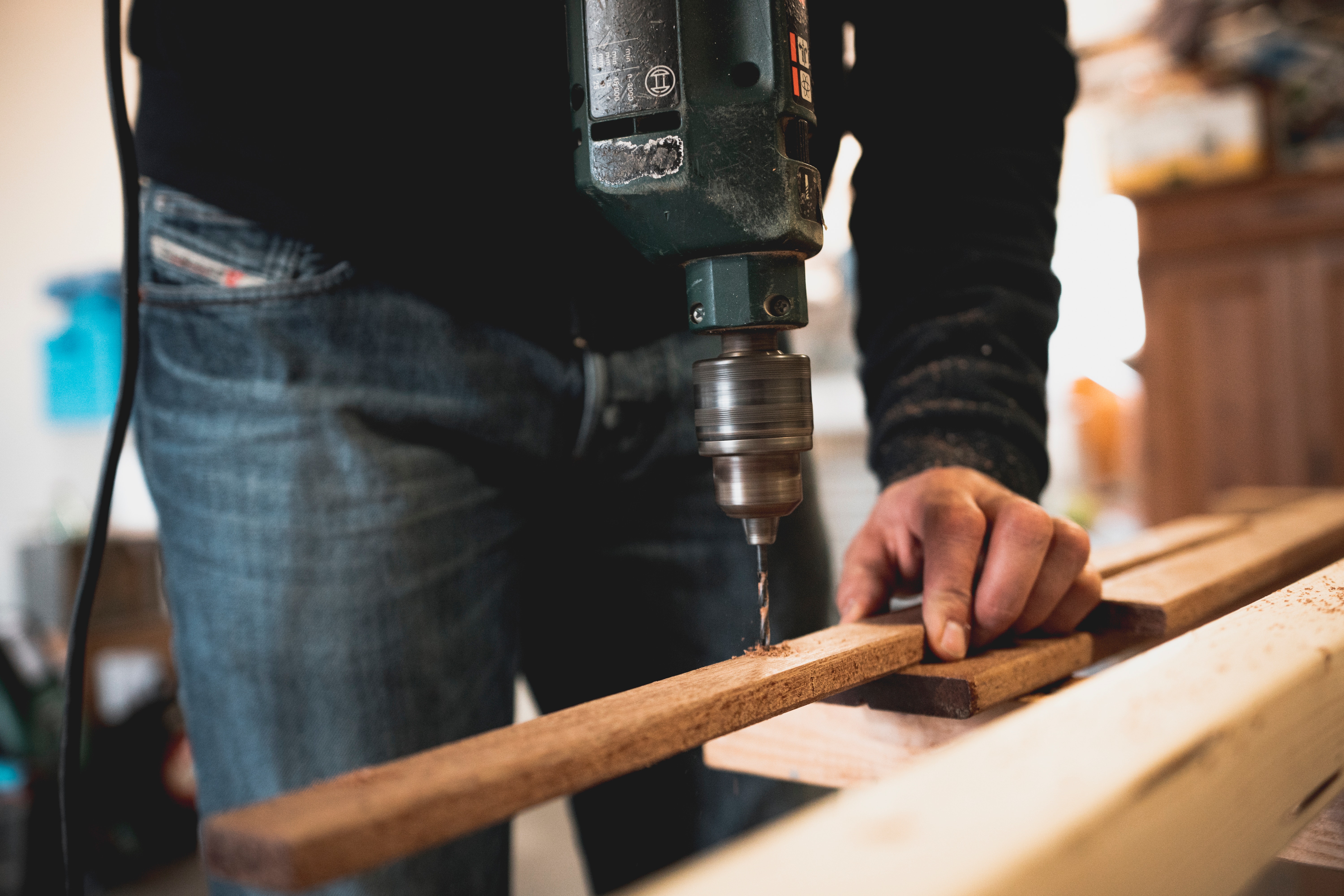 Man using his worktables for garage at home. 